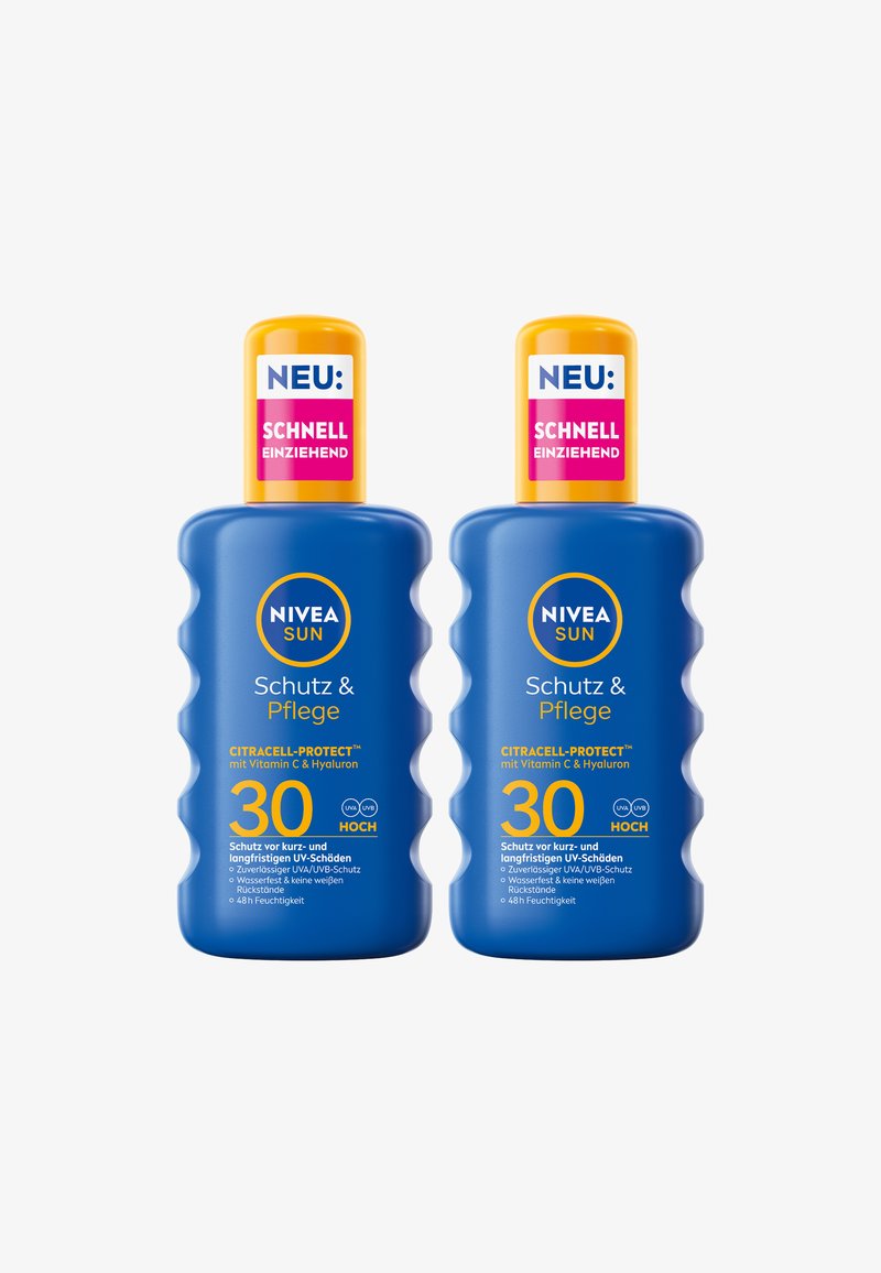 Two blue Nivea Sun SPF 30 sunscreen bottles with yellow caps and labels highlighting quick absorption and UV protection.