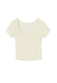 Crop top en dentelle crème avec un décolleté carré, des manches courtes et des motifs floraux. Texture douce et design ajusté.