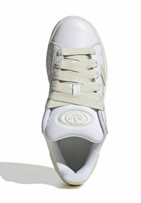 White athletic shoe with a smooth leather upper, beige fabric laces, padded collar, and a logo patch on the tongue. Rounded toe design.