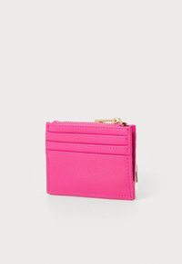 Pink wallet made of textured material with a zip closure, featuring multiple card slots and a gold-tone zipper pull.