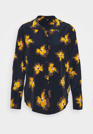 Chemise bleu marine avec motif floral jaune et marron, manches longues, boutons sur le devant et col. Tissu lisse et léger.