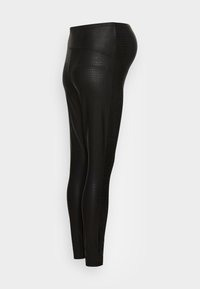 Black leggings with a textured crocodile pattern, made from a smooth, stretchy material. High-waisted design allows for comfort and flexibility.
