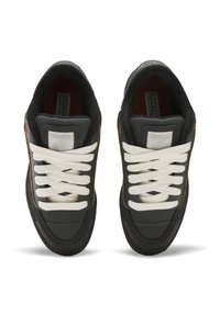 Black sneakers with white laces, featuring a suede and textile upper, rounded toe, and gold accents on the side. Soft, padded tongue and collar.