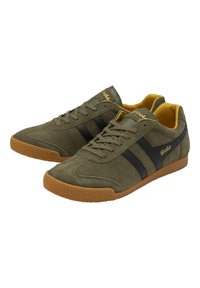 Sneakers in suede verde oliva con strisce nere, logo dorato e suola in gomma testurizzata; punta arrotondata e design con lacci.