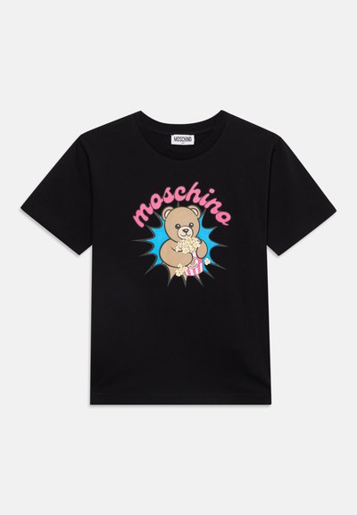 Черна тениска с къси ръкави с карикатурен мечок, държащ пуканки, и "moschino" в розов текст над него на син фон с избухване.