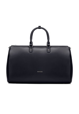 Borsa da viaggio in pelle nera con doppia maniglia e piccolo logo dorato del marchio al centro davanti.