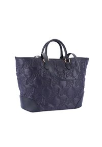 Tikkulinen tummansinisestä kankaasta valmistettu kassi, jossa tummanruskeat nahkaosat, kaksoiskahvat ja kukkakuviot. Mitat sopivat päivittäiseen käyttöön.