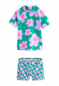 Kortsleeve rash guard och shorts set i grönt med stora rosa blommor. Tillverkat av elastiskt material, har en dragkedja och resårmidja.