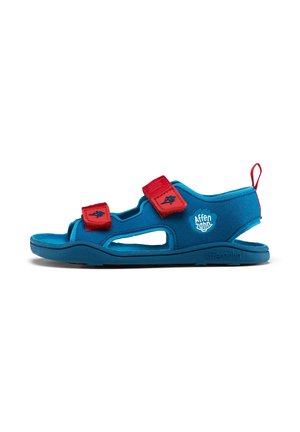 Blue sandal with red Velcro straps, open design featuring cutouts. Made from soft materials, showcasing a textured surface and logo detail.