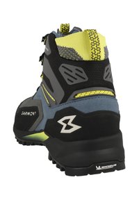 Bota de senderismo Garmont con un diseño en gris, azul y negro, con una parte superior texturizada, acentos de malla y una suela con dibujo Michelin para un mejor agarre.