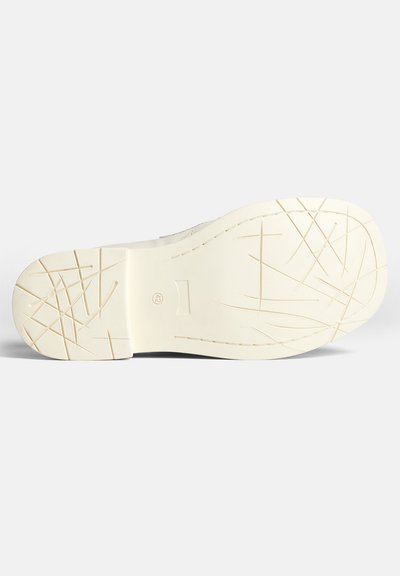 White rubber shoe sole with textured grip pattern, featuring ridges and grooves for traction. Size marked as 42.