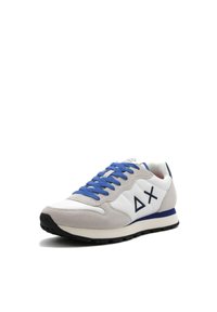 Sneakers che presentano una combinazione di pelle bianca, suede grigia e lacci blu. Il design notevole include un logo geometrico sul lato e una suola in gomma nera.