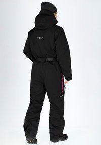 Black waterproof snowsuit with a hood, belted waist, pink zipper accents, and reinforced cuffs. Textured fabric for durability and warmth.