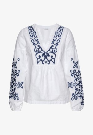 Bijela lanena bluzica s vezom cvjetnih i spiralnih uzoraka u tamnoplavoj boji. Ima V-izrez i elastične manžete na dugim rukavima.