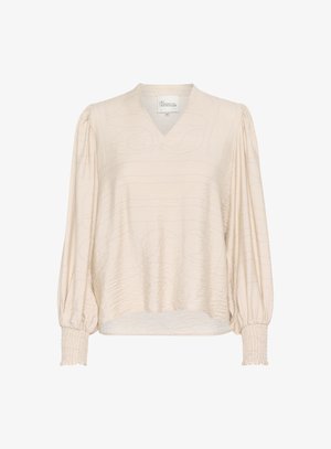 Cremefarbene Bluse mit V-Ausschnitt, langen Puffärmeln und smockierten Manschetten. Verfügt über ein strukturiertes Muster für zusätzlichen Detailreichtum. Weicher, glatter Stoff.