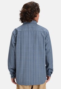 Langarmshirt, blauw-witte geruite patroon, knoopmanchetten, gespreide kraag, gestructureerde stof, heuplengte, rechte achterkant.