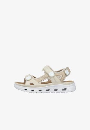 Beige sandalen met verstelbare banden, een gevoerde binnenzool en een witte rubberen zool met luchtopeningen. Gemaakt van synthetische materialen.