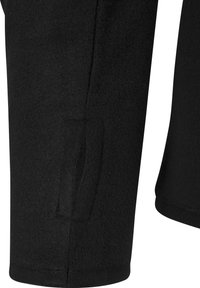 Mânică de haină din fleece negru cu o deschidere verticală a buzunarului și o margine cusută la manșetă.