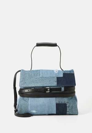 Patchwork denim handbag with light and dark blue panels, black leather handle, wraparound black belt, and adjustable shoulder strap.