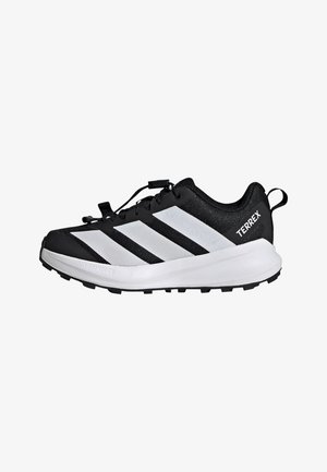 Black and white athletic shoes featuring a breathable mesh upper, three signature stripes, lace closure, and a textured rubber sole.