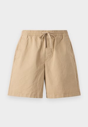 Beżowe bawełniane szorty z elastycznym paskiem i regulowanym troczkiem, z bocznymi kieszeniami i luźnym krojem. Gładka tekstura, długość do kolan.