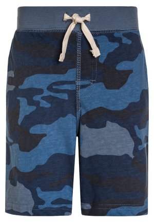 Shorts imprimés camouflage bleu et noir avec une ceinture élastique grise et un cordon blanc noué en nœud devant au centre.