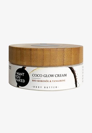 Contenitore rotondo di burro per il corpo con coperchio in bamboo. L'etichetta mostra il nome del prodotto "Coco Glow Cream" e gli ingredienti, con uno sfondo bianco e testo nero.