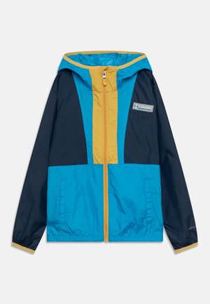 Veste légère Columbia avec capuche, présentant des panneaux bleu, marine et jaune, fermeture éclair sur l'avant, et deux poches latérales.