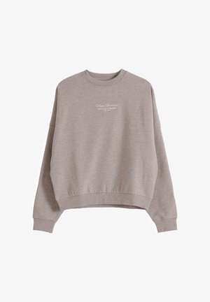 Light brown crewneck sweatshirt with ribbed cuffs and hem, featuring small white text "Almond Sportswear" on the chest.