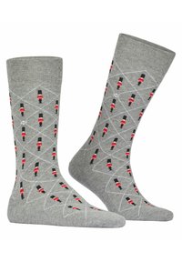 Calze di cotone grigie con un motivo ripetuto di soldatini in rosso e nero, su uno sfondo di design a linee bianche a forma di diamante.