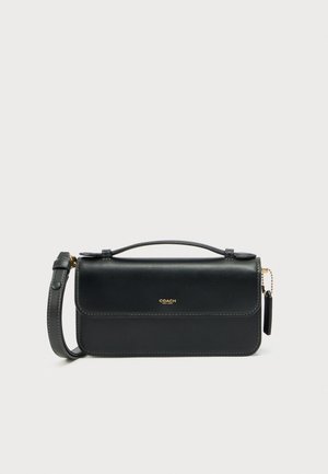Black leather crossbody bag with a flap closure, gold hardware, and a detachable shoulder strap. Features visible stitching accents.