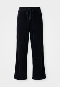 Pantalon en velours côtelé noir avec une coupe ample, dotés d'une taille élastique et d'un cordon de serrage. La texture est côtelée et le tissu semble doux.