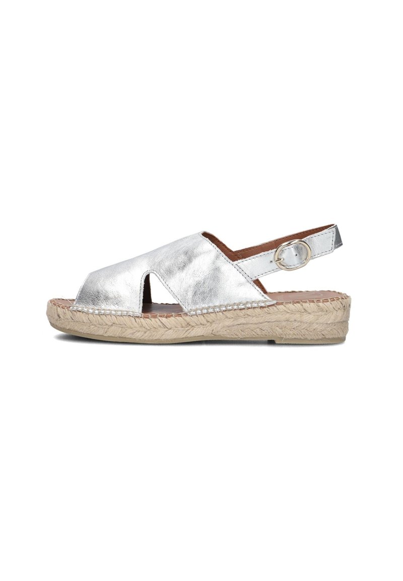 Silver metallic sandal with a cutout design, adjustable ankle strap, and woven jute sole. Smooth texture with a flat heel.