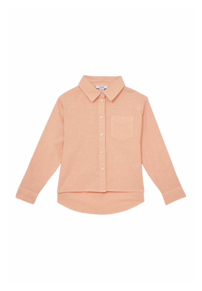 Light peach long-sleeve button-up shirt with a pointed collar, chest pocket, and a hem that curves at the back. Soft texture and relaxed fit.