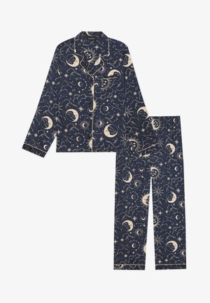 Navy pajama set featuring celestial patterns of moons, stars, and clouds, with cream accents, long sleeves, and straight-leg pants.