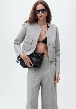 Gray cropped jacket with two front pockets, paired with matching wide-leg pants and a black woven bag. Black sunglasses complete the look.