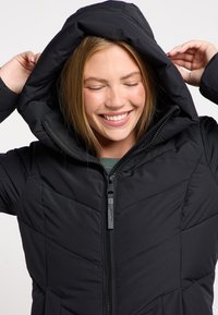 Black padded jacket with a hood, featuring a front zipper and triangular quilting pattern. The fabric has a smooth, matte texture.