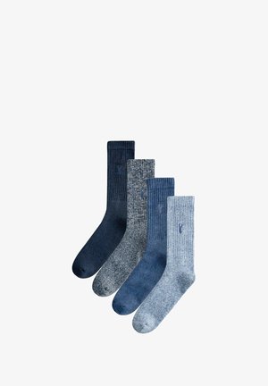 Four pairs of socks in various shades of blue, featuring ribbed and textured patterns, with a light blue logo on each pair.