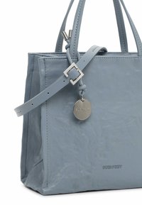 Light blue leather handbag with a textured finish, features two handles, a detachable strap, and a silver charm logo tag.