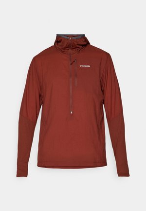 Men's rust-colored Patagonia long-sleeve pullover with quarter-zip and high collar, featuring a small chest logo.