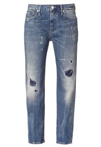 Džíny z denimu s středním praním a volným střihem, s třepeným lemem, roztrhanými záplaty a vybledlým vzhledem, obklopené klasickým pětikapsovým designem.