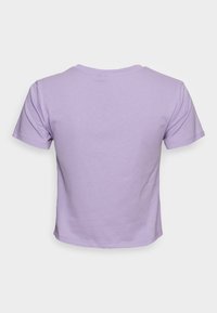 Camiseta de manga corta en color lila con escote redondo, fabricada en un tejido suave y con un diseño cropped que presenta una textura lisa y bordes limpios.
