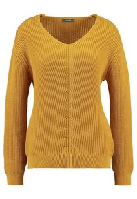 Żółty, dziergany sweter z dekoltem w serek, długimi rękawami, ściągaczami na mankietach i dole oraz teksturowanym wzorem i centralnym zdobieniem na guziki.
