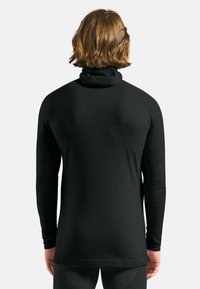 Black long-sleeve thermal top with a mock neck, ribbed texture, and raglan sleeves, designed for thermal insulation.