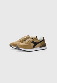 Brown suede and mesh sneakers with black accents, cream inner lining, textured surface, and white midsole. Rubber outsole for traction.