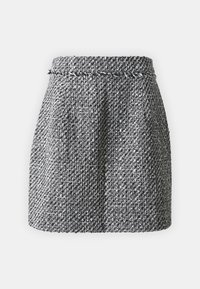 Jupe en tweed noir et blanc avec une taille cintrée, un tissu texturé et une forme légèrement évasée. Présente un détail de taille tressé.