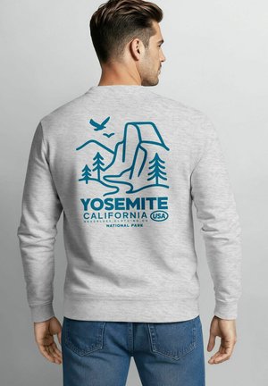 Heather grey sweatshirt features a blue Yosemite National Park graphic with mountains, trees, and a river; long sleeves and ribbed cuffs.