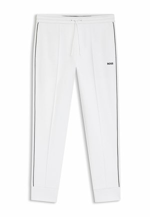 White jogger pants with black side stripes, drawstring waist, ribbed cuffs, and "BOSS" logo on the right thigh.