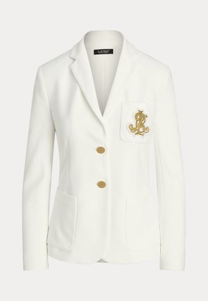 White tailored blazer with notched lapels, gold buttons, patch pockets, and a chest pocket featuring a gold embroidered emblem.