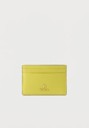 Yellow leather cardholder with three horizontal slots and gold Furla logo centered on front against white background.